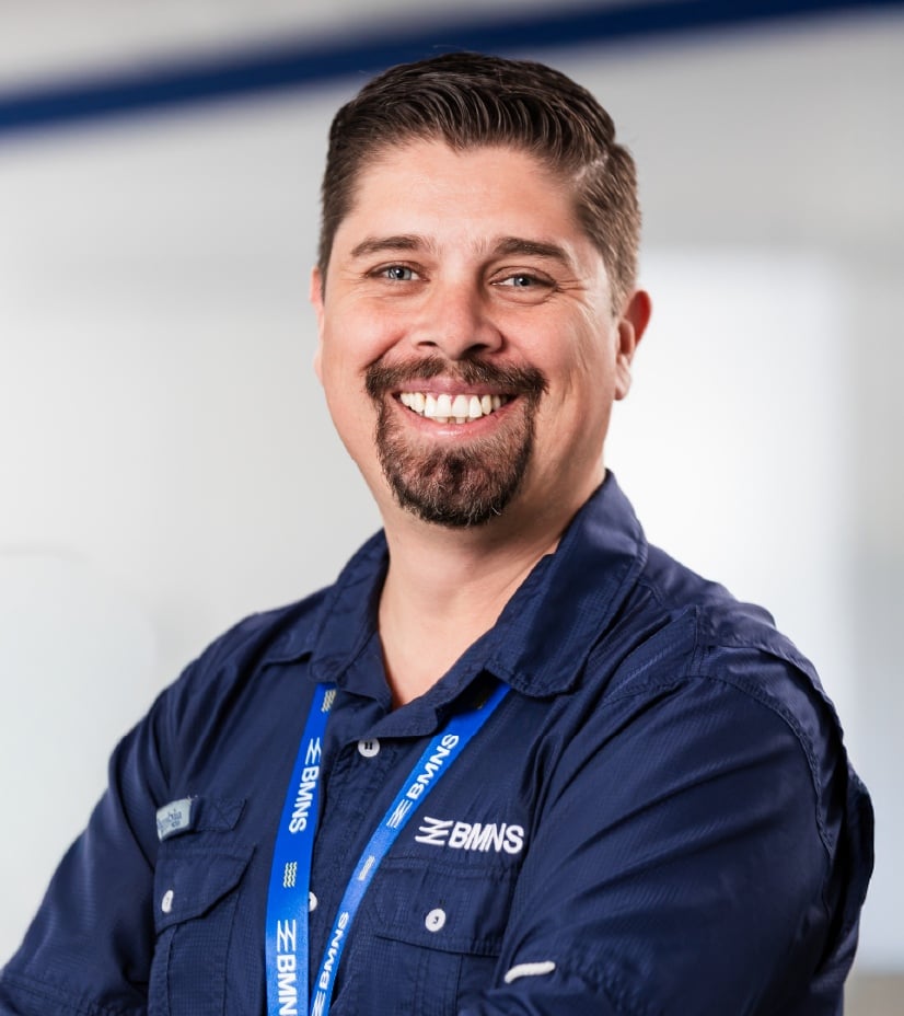 BMNS - Smiling professional with BMNS lanyard and blue shirt
