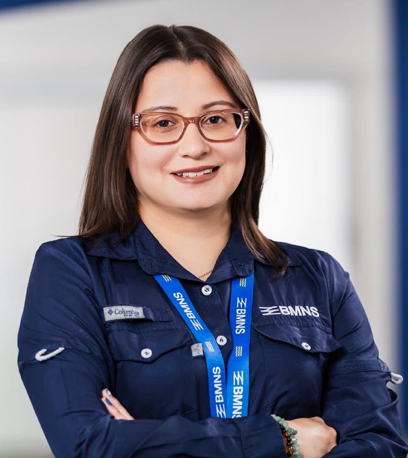 BMNS - Smiling professional with BMNS lanyard and blue shirt
