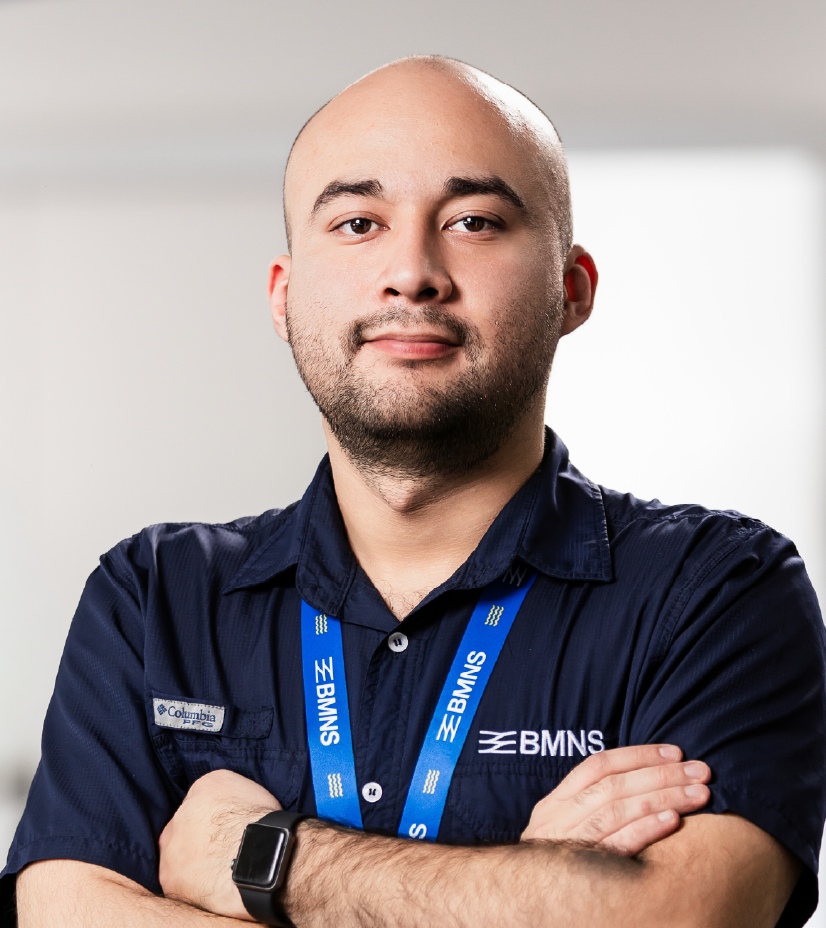 BMNS - Smiling professional with BMNS lanyard and blue shirt