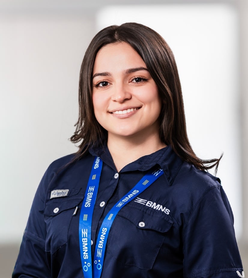 BMNS - Smiling professional with BMNS lanyard and blue shirt