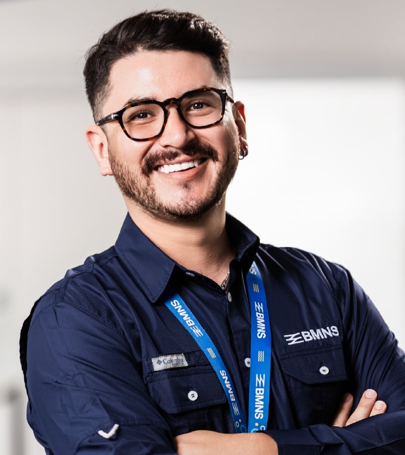BMNS - Smiling professional with BMNS lanyard and blue shirt