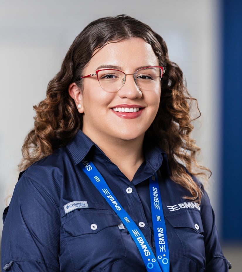 BMNS - Smiling professional with BMNS lanyard and blue shirt