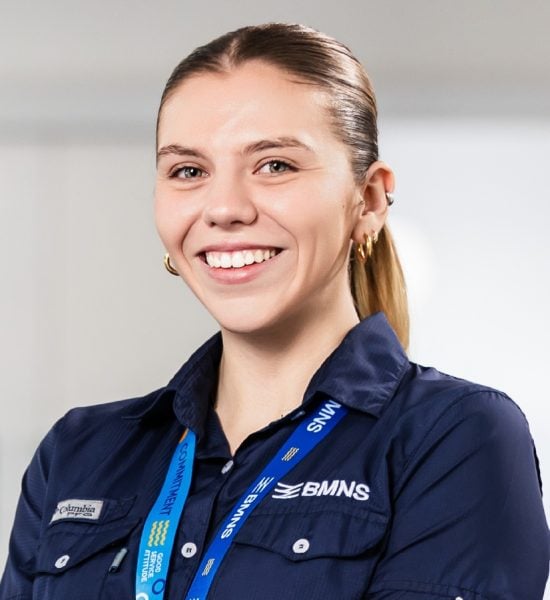 BMNS - Smiling professional with BMNS lanyard and blue shirt