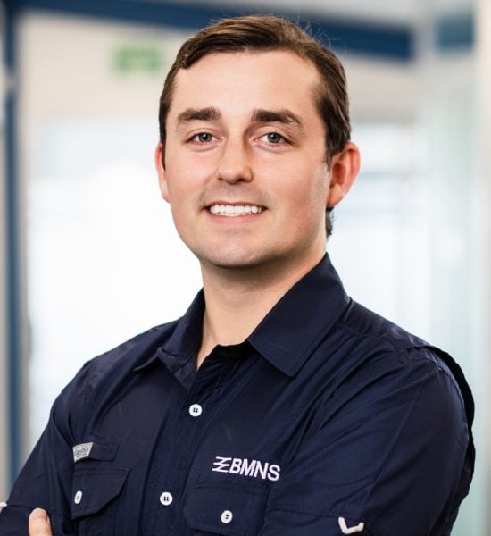 BMNS - Smiling professional with BMNS lanyard and blue shirt