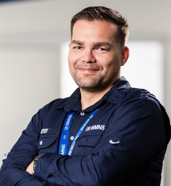 BMNS - Smiling professional with BMNS lanyard and blue shirt