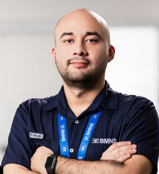 BMNS - Smiling professional with BMNS lanyard and blue shirt