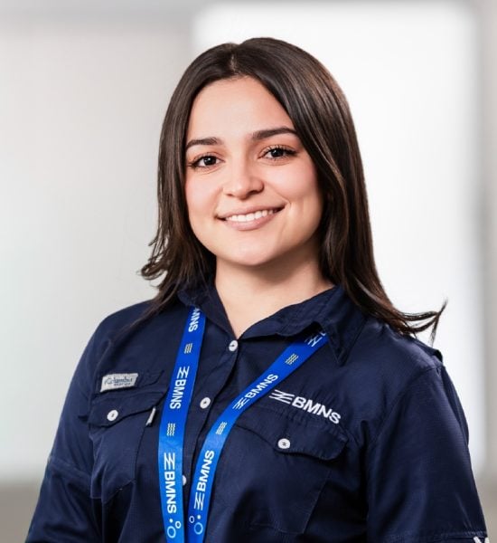 BMNS - Smiling professional with BMNS lanyard and blue shirt