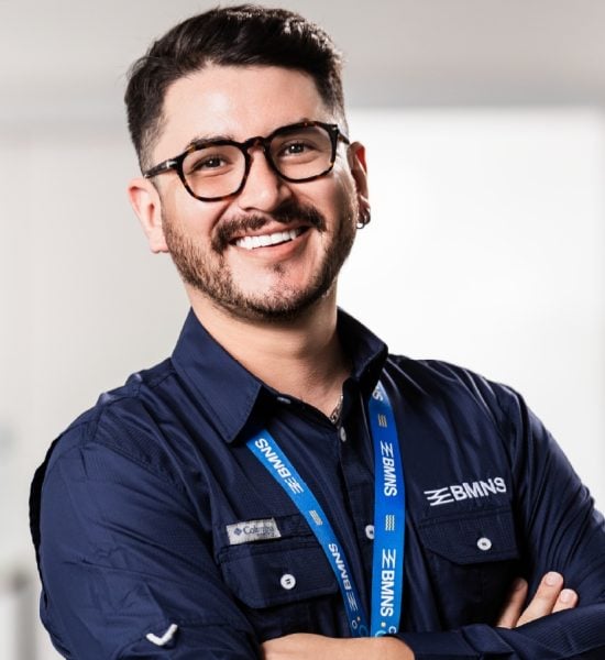 BMNS - Smiling professional with BMNS lanyard and blue shirt