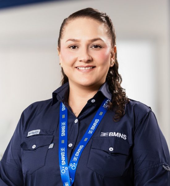 BMNS - Smiling professional with BMNS lanyard and blue shirt