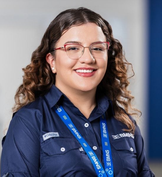 BMNS - Smiling professional with BMNS lanyard and blue shirt