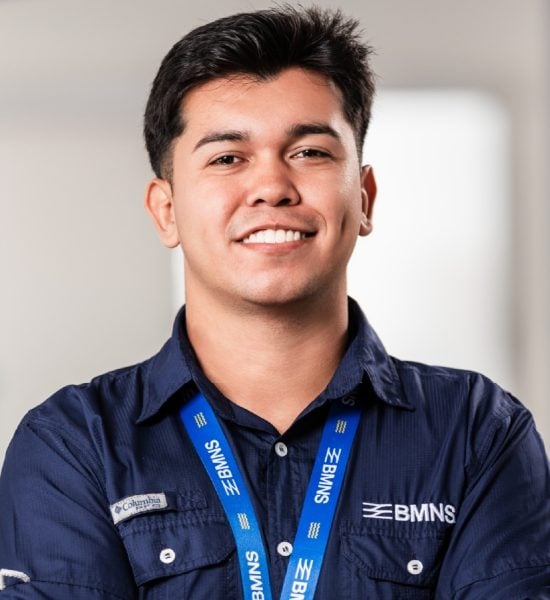 BMNS - Smiling professional with BMNS lanyard and blue shirt